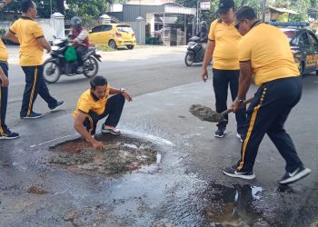 Cegah Laka Lantas, Polsek Balongbendo Lakukan Bhakti Keselamatan Tambal Jalan Berlubang